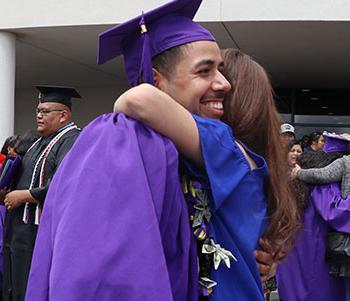 Mom hugging her San Juan College Graduate student.